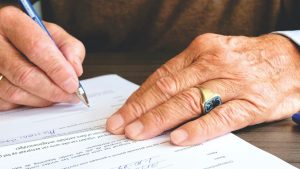 Montrose man signing his official last testament with witnesses